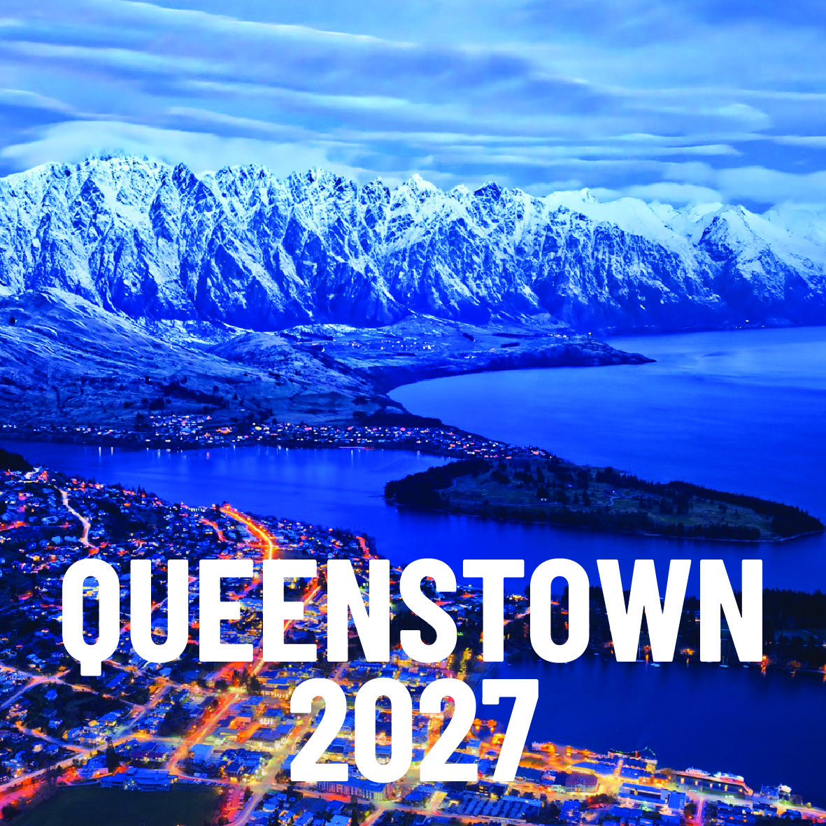 Queenstown 2027 — twilight aerial of the snow-capped Remarkables, lake and city lights
